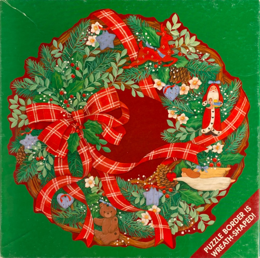 A lush Christmas wreath decorated with ornaments, plaid ribbon, a teddy bear, and Santa Claus on a bright green background.