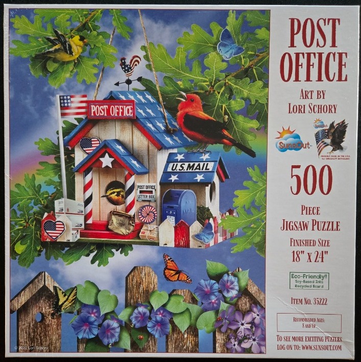 A birdhouse shaped like a US Post Office hangs in a tree surrounded by birds, butterflies, and a garden fence.