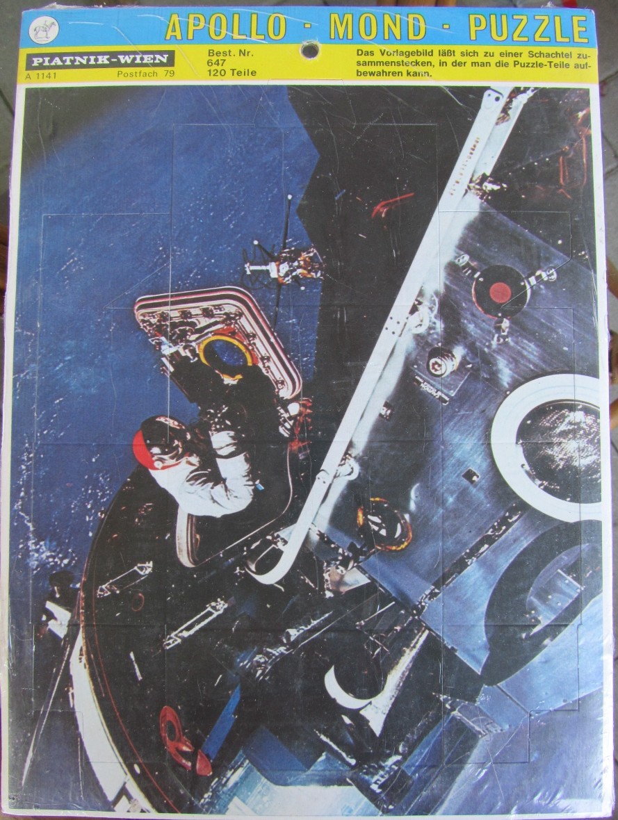 An overhead view of an astronaut working outside a spacecraft in orbit above Earth.
