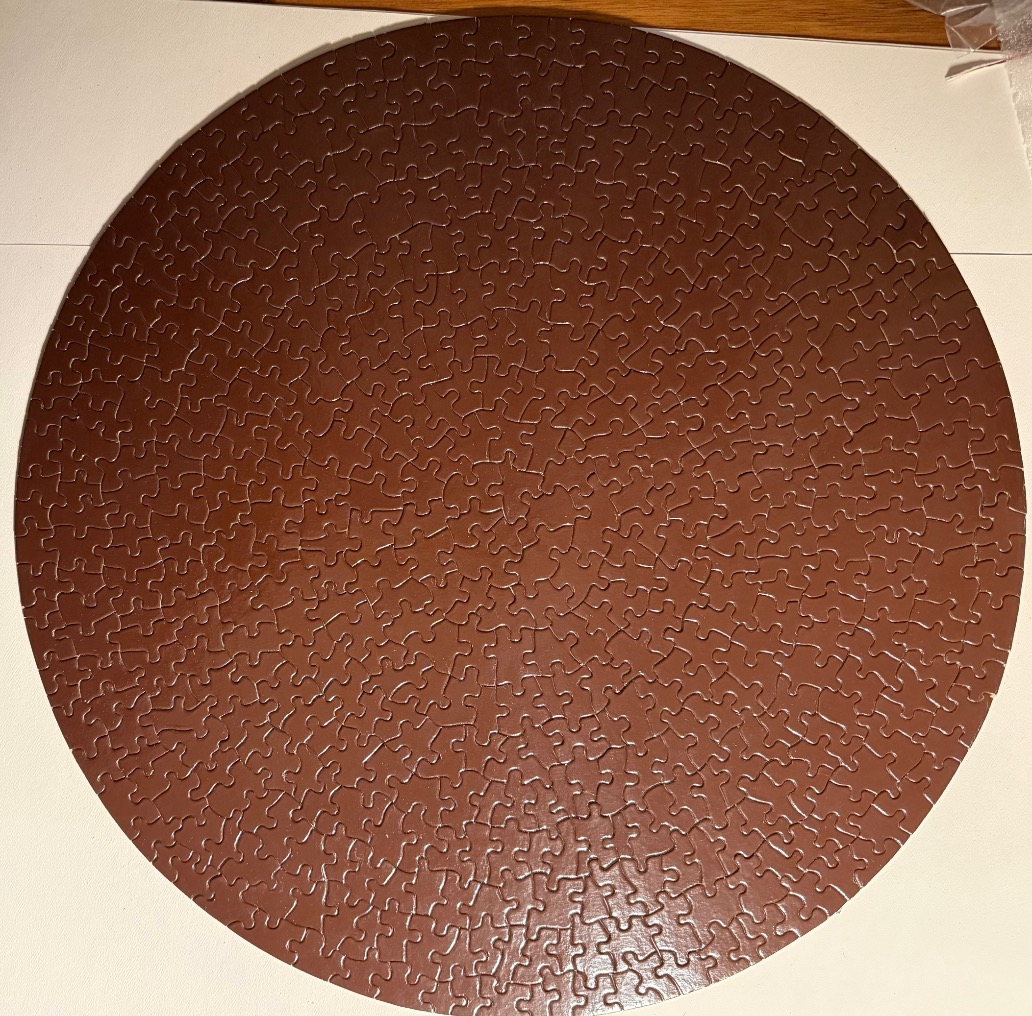 A solid dark brown circular field.
