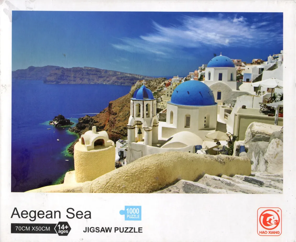 Scenic view of Oia, Santorini, featuring iconic blue-domed churches overlooking the Aegean Sea.