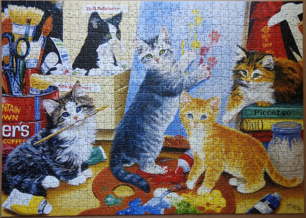 An illustration of five kittens playing in an art studio with paint supplies and reference books.