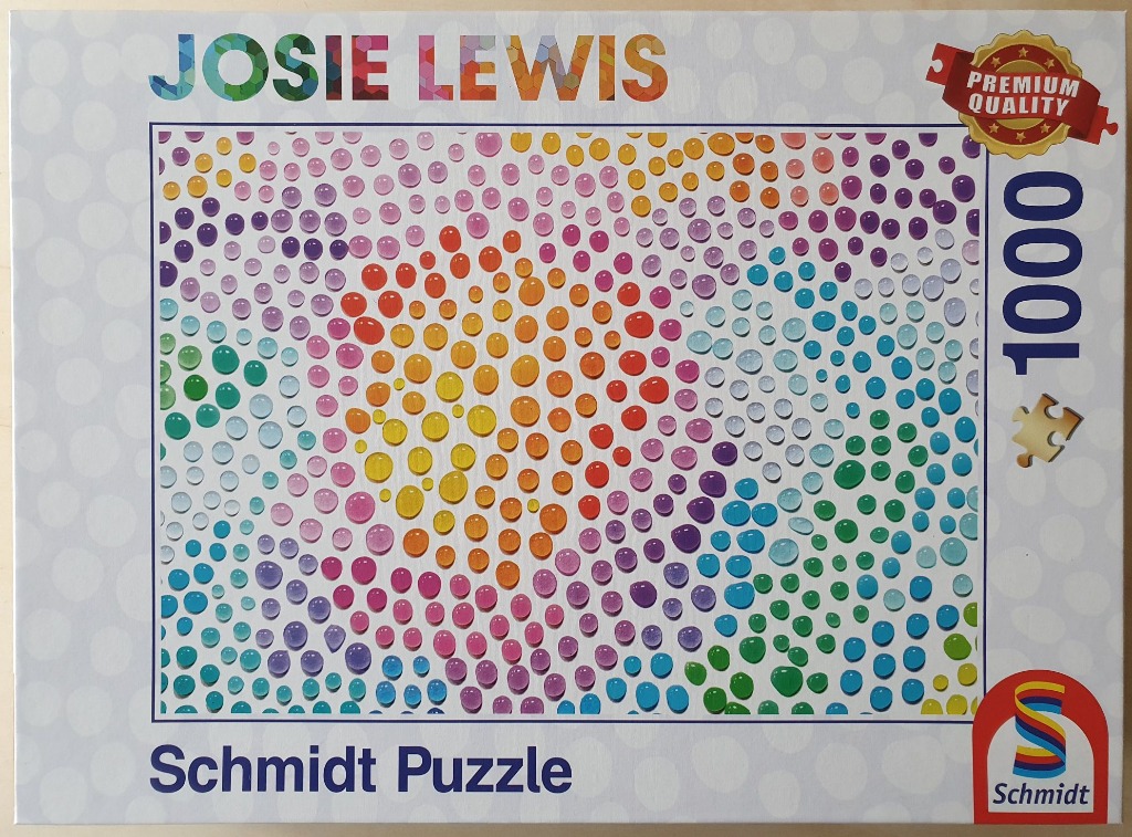 Abstract artwork featuring a dense, gradient-patterned field of colorful, translucent circular droplets.