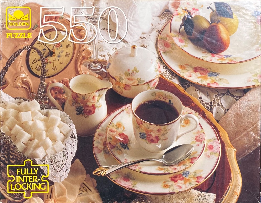 A still life scene featuring a teacup, sugar cubes, and floral-patterned porcelain on a lace tablecloth.