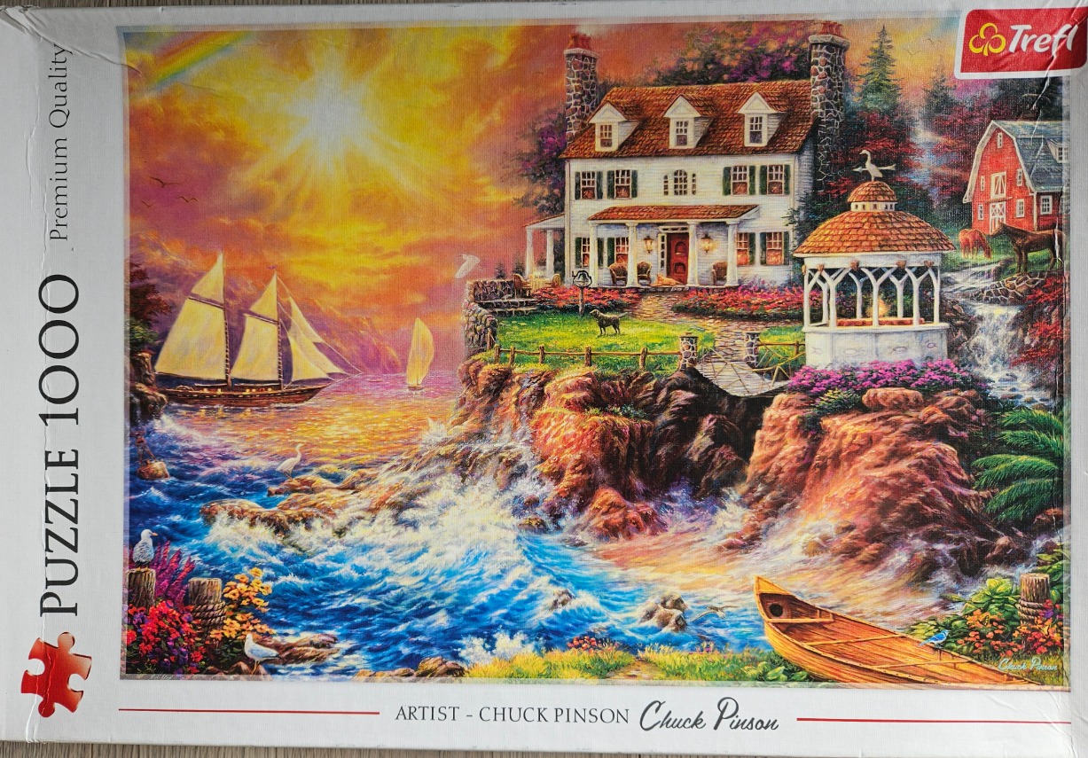A romanticized coastal landscape featuring a white house on a cliff, a gazebo, and a sailboat during a vibrant sunset.