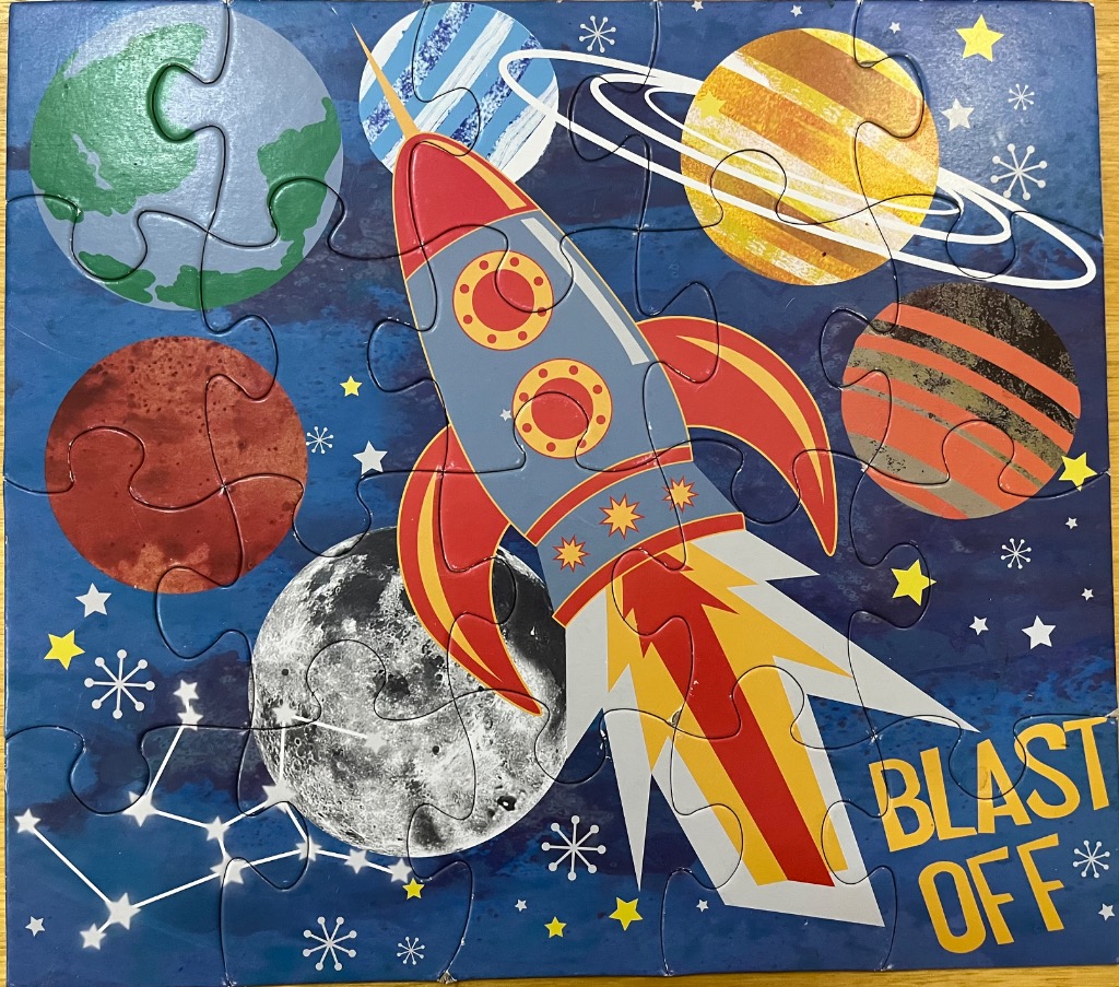 A cartoon illustration of a colorful rocket flying through a space scene with planets, stars, and the text BLAST OFF.