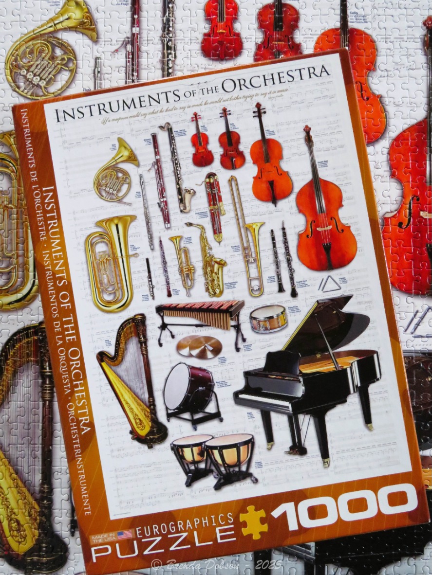A collection of various orchestral musical instruments displayed on a sheet music background.