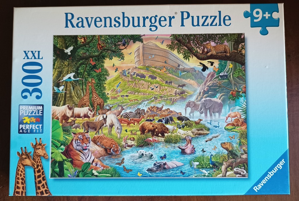 A lush, vibrant illustration of Noah’s Ark resting on a mountainside, surrounded by a large collection of diverse animals.