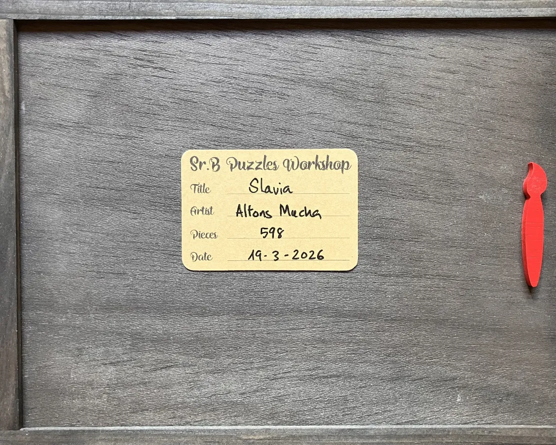A rectangular information label on a dark wood grain background next to a red paintbrush-shaped icon.