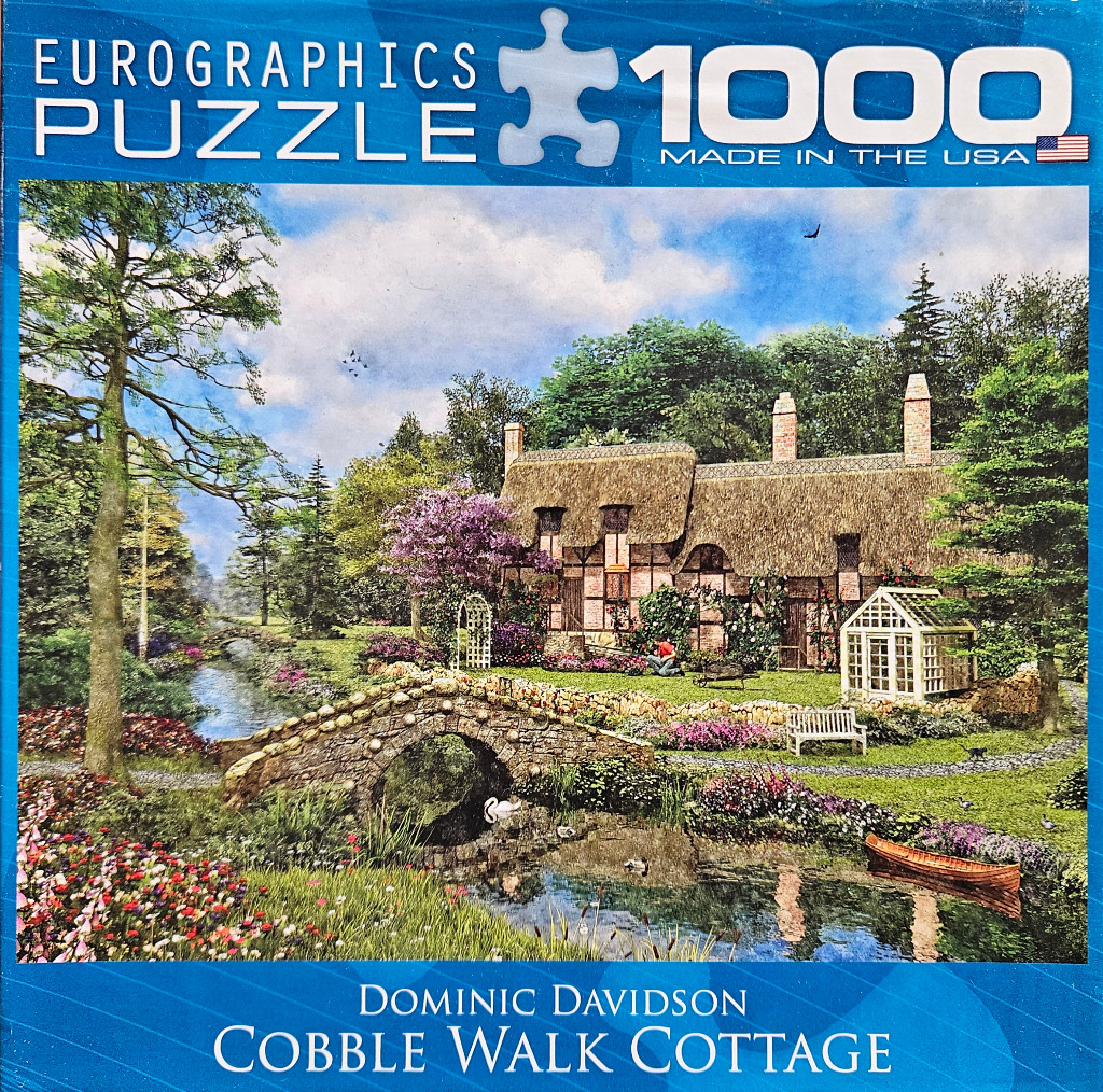 A peaceful English cottage scene with a thatched roof, stone bridge, and a winding stream.