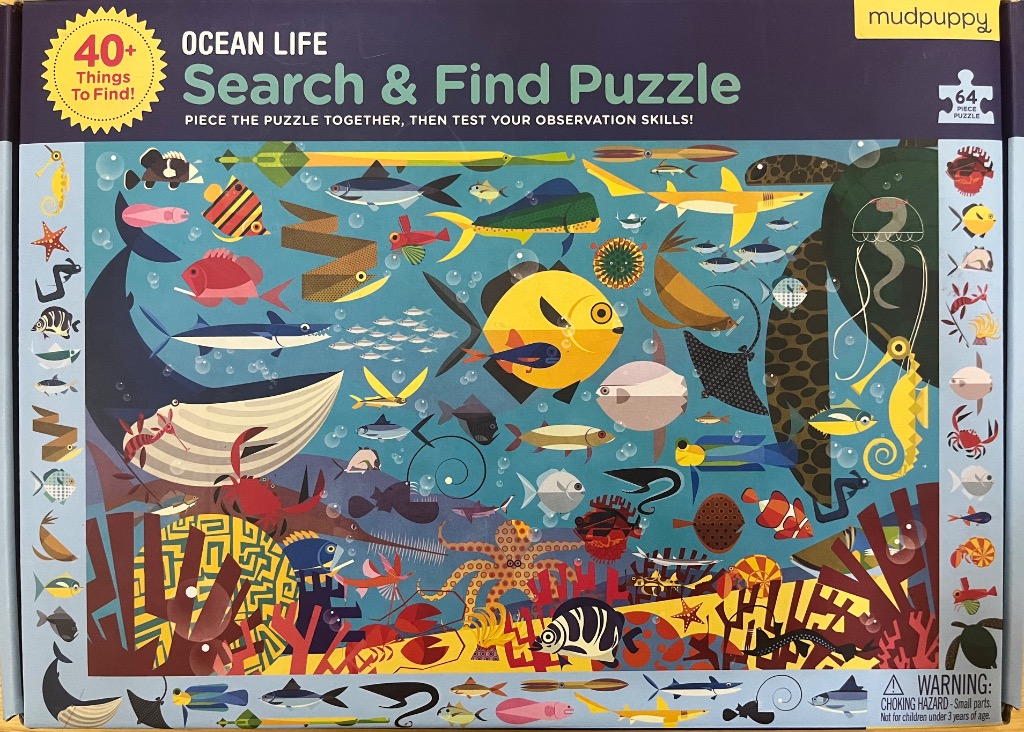 Colorful cartoon illustration of diverse ocean sea life teeming in deep blue water.