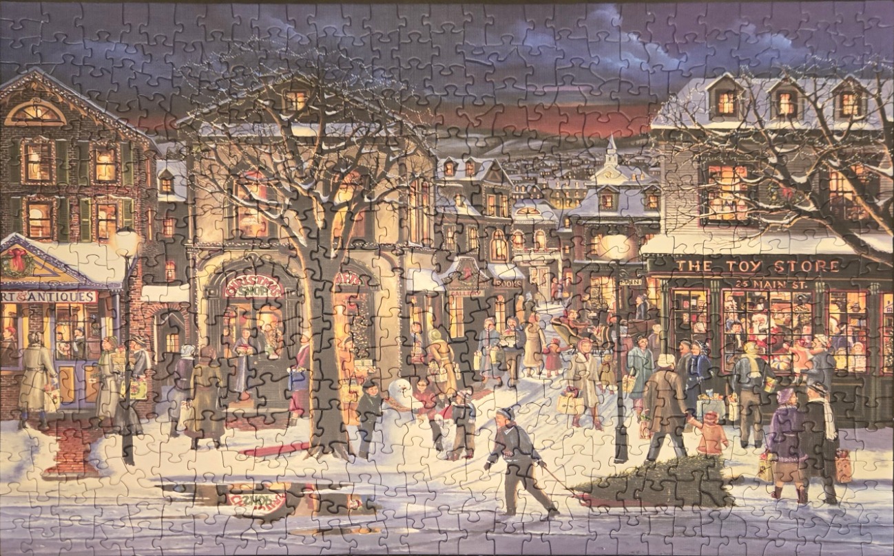 A festive illustration of a snowy Main Street scene at dusk with shops, holiday shoppers, and warm lighting.