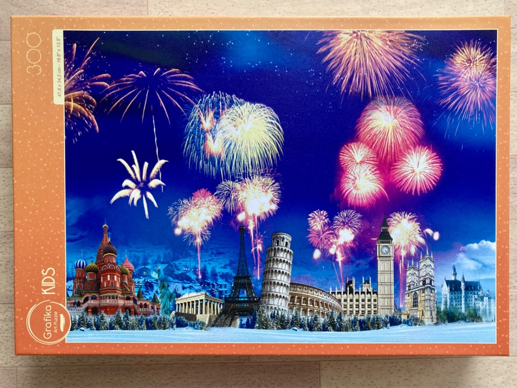 Composite image of world landmarks against a night sky filled with fireworks
