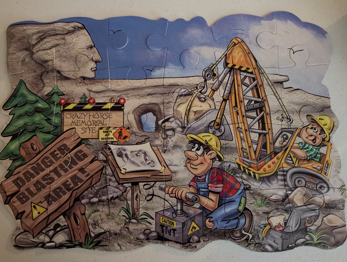 A cartoon illustration of workers at the Crazy Horse Memorial construction site.