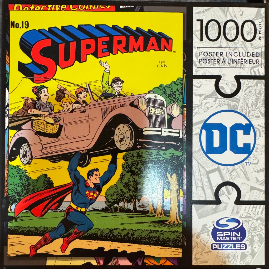 Superman holding up a vintage car with a family inside