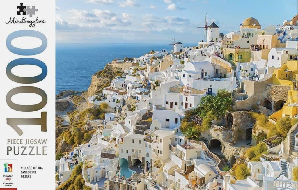 A scenic photograph of the Oia village in Santorini, Greece, featuring whitewashed buildings and windmills on a cliff.