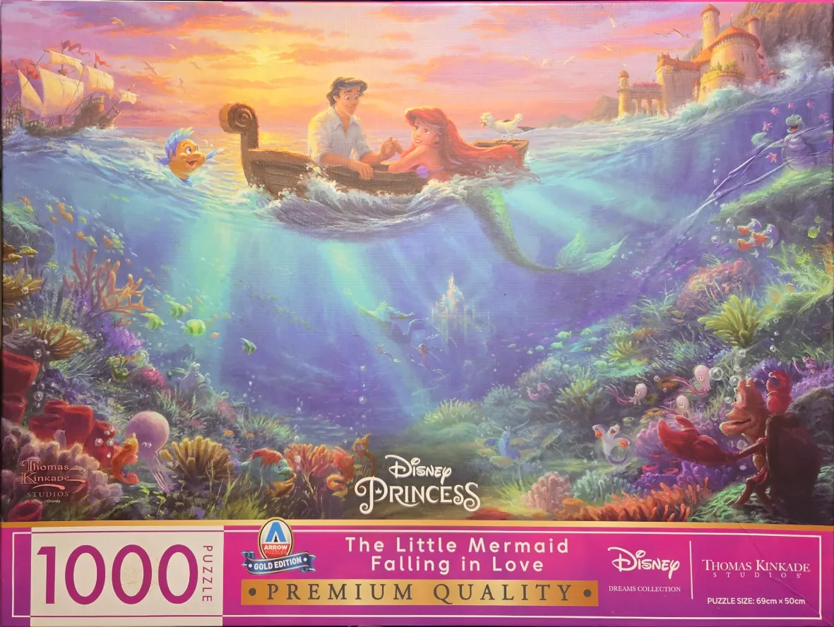 A romantic scene of Prince Eric and Ariel in a rowboat above a vibrant underwater coral reef.