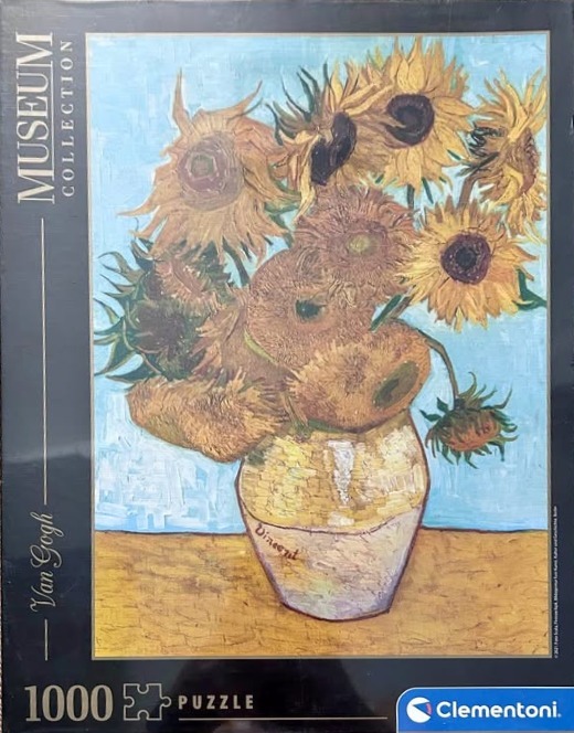 Vincent van Gogh's Sunflowers still life painting in a yellow vase against a pale blue background.