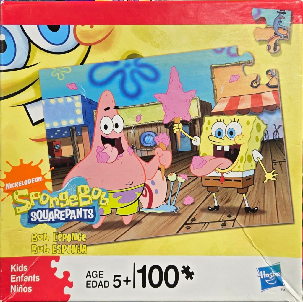 SpongeBob SquarePants and Patrick Star eating pink cotton candy on a wooden boardwalk.