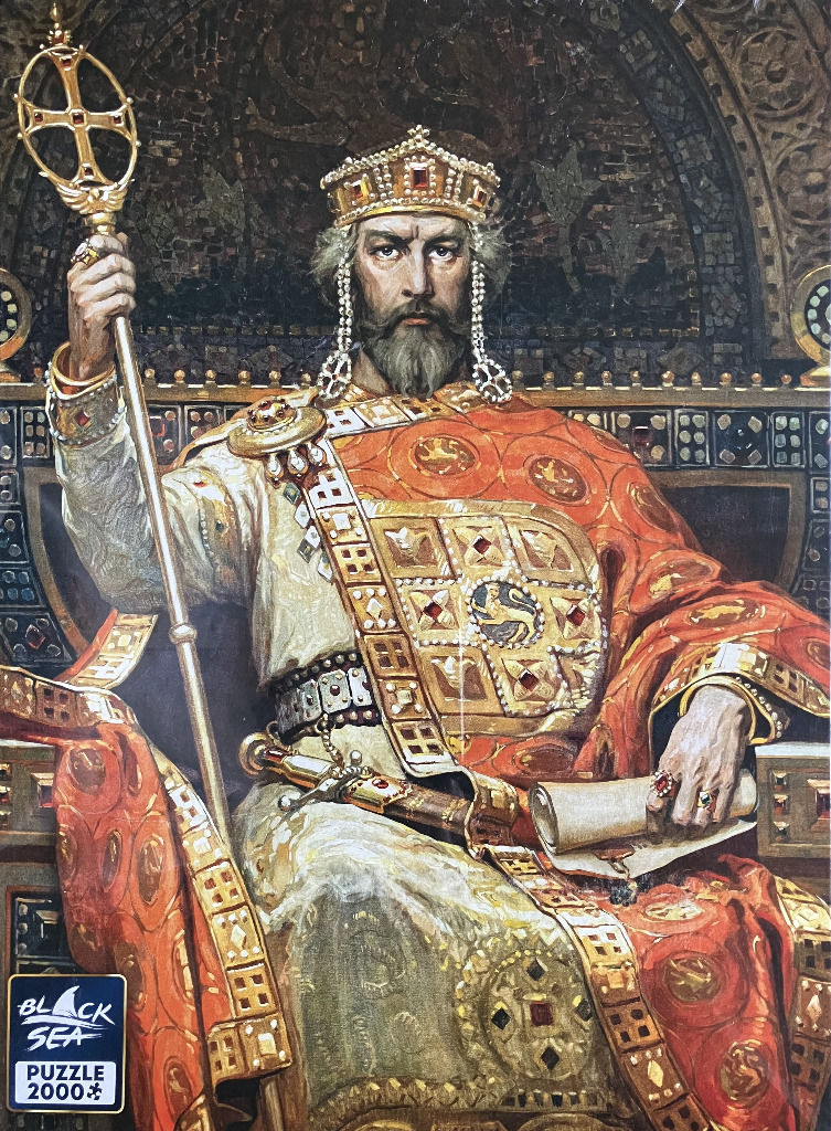 A formal portrait of a Byzantine-style emperor sitting on a throne, holding a tall staff and a parchment scroll.