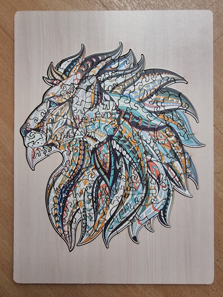 A stylized artistic illustration of a lion's head profile decorated with geometric patterns and cool-toned colors.