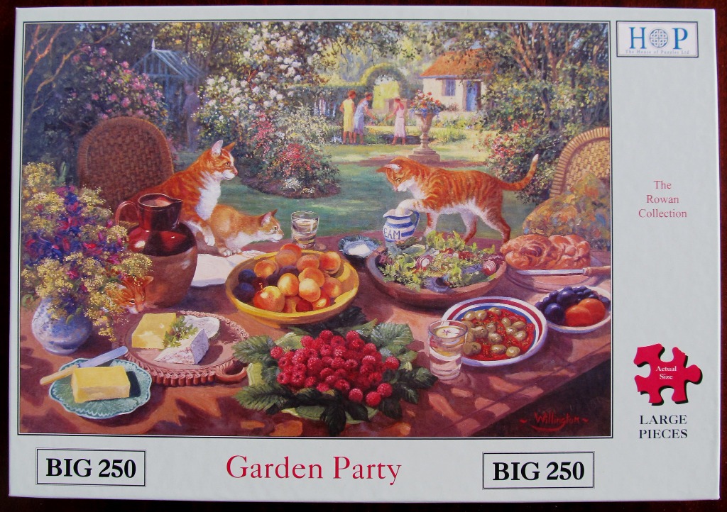 Two ginger cats investigate a picnic table laden with food in a lush English garden.