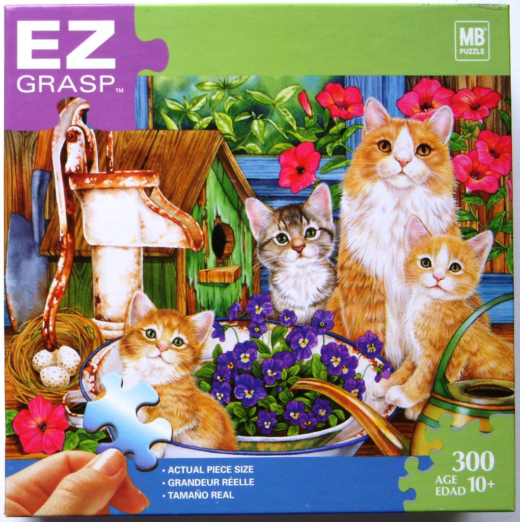 Four ginger and tabby kittens gathered in a rustic garden setting with a water pump and flowers.