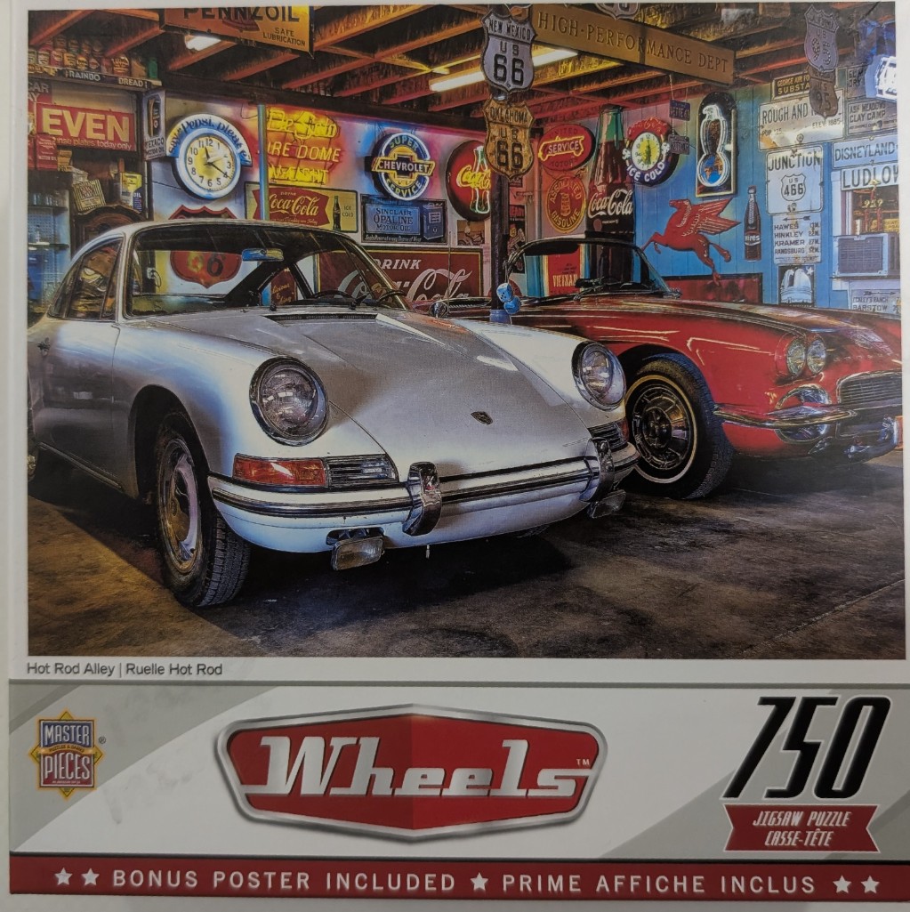 A silver vintage Porsche and a red convertible parked in a garage filled with Americana and vintage signs.