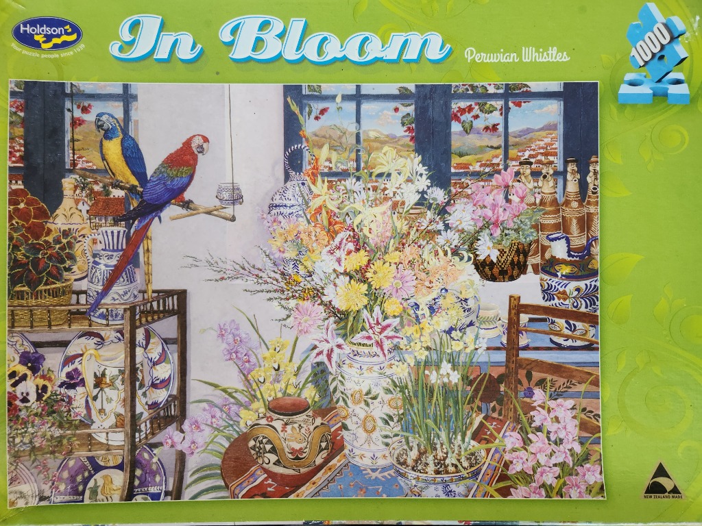 Still life painting of a sunny room with two macaws, ceramic vases, and a large, colorful bouquet of flowers.