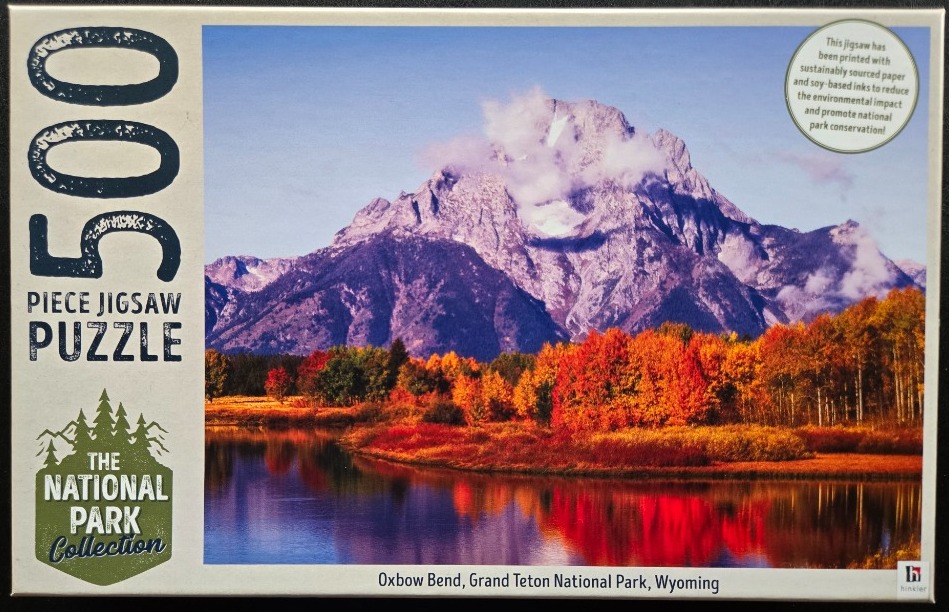 Scenic photograph of Oxbow Bend in Grand Teton National Park during autumn with a mountain in the background.
