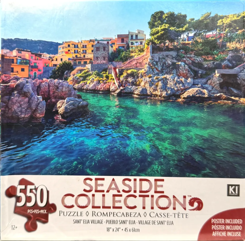 A Mediterranean village with colorful houses on a rocky coastline overlooking turquoise water.