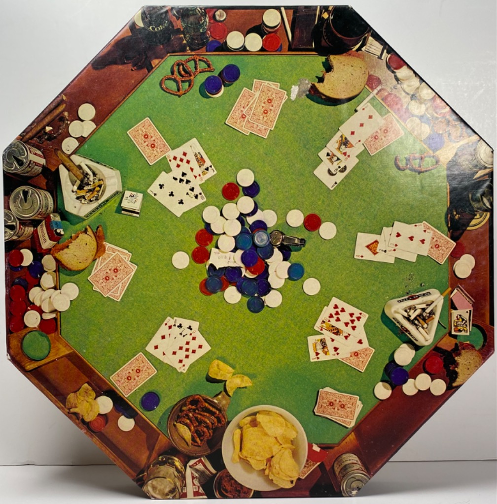 Overhead view of an octagonal poker table cluttered with cards, chips, snacks, and drinks.