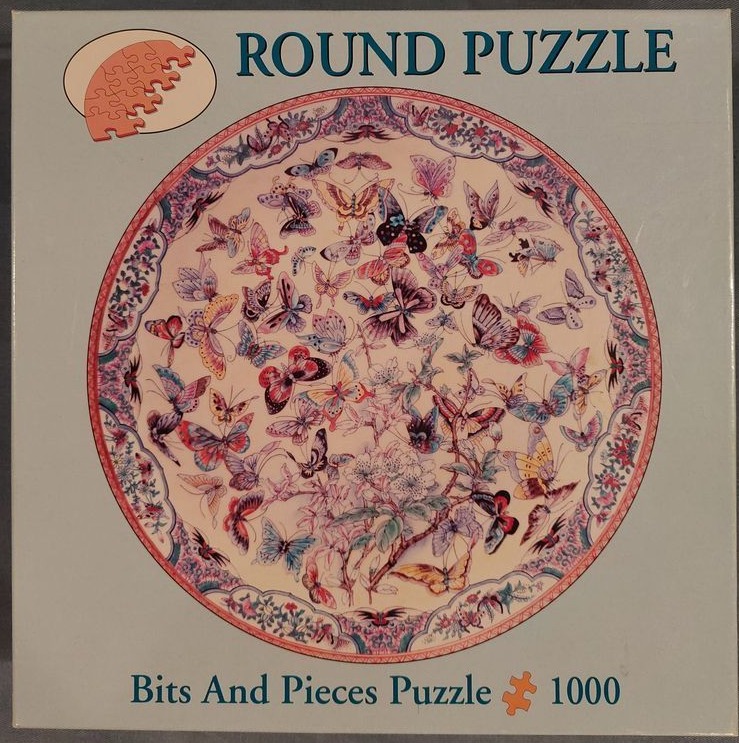 A round decorative plate illustration featuring a swarm of colorful butterflies around blossoming floral branches.