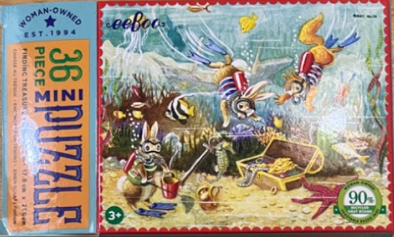 Illustration of three rabbits scuba diving to find a treasure chest on the ocean floor.