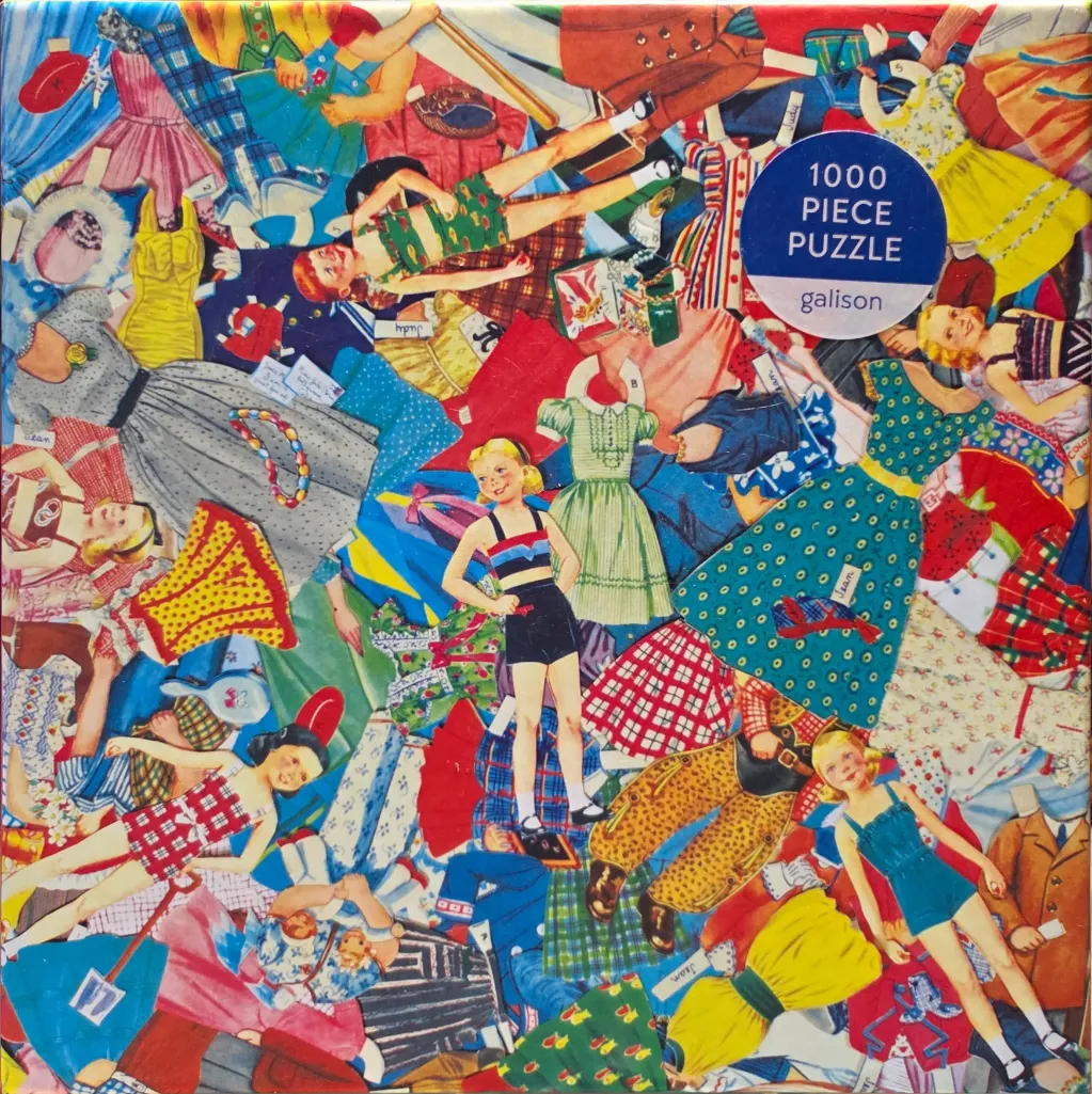 A collage of vintage paper dolls and outfits in a chaotic, overlapping pattern.