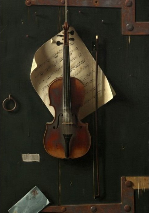 A violin and bow hanging against a dark wooden door with sheet music.