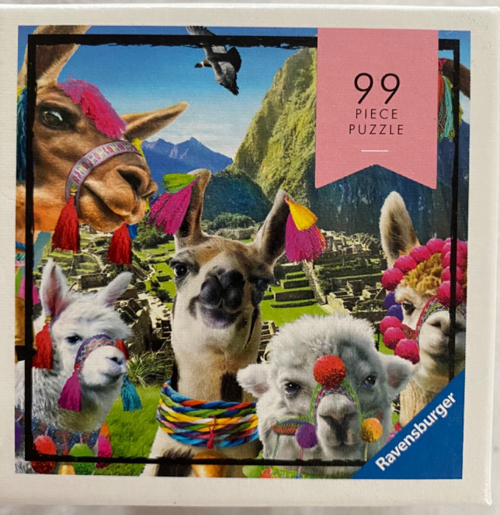 Four llamas adorned with colorful tassels and pom-poms against a background of Machu Picchu.