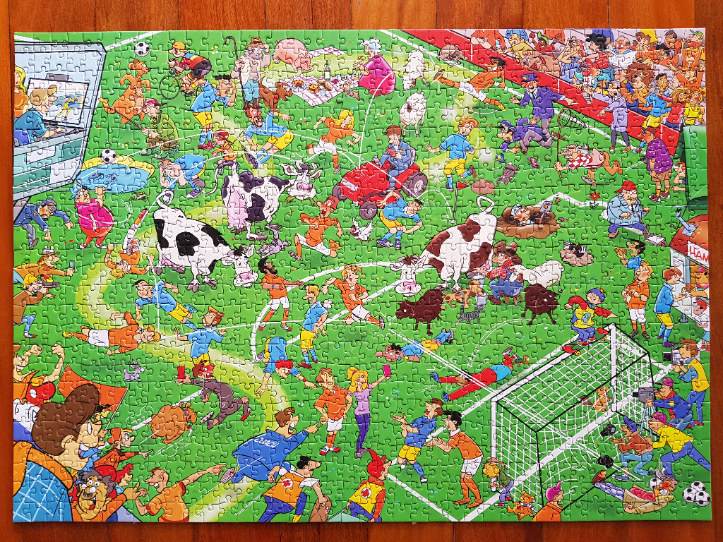A chaotic cartoon scene on a soccer field featuring cows, farm animals, and spectators.