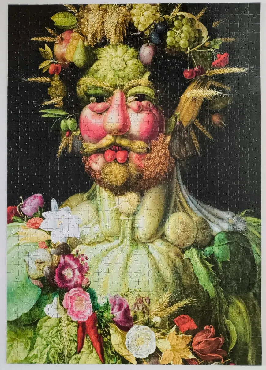 An anthropomorphic portrait of a man composed entirely of fruits, vegetables, flowers, and wheat against a black background.