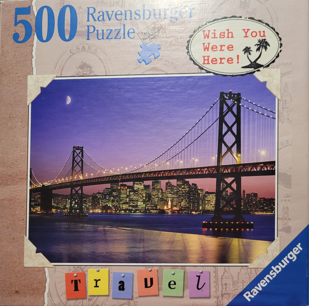 A twilight photograph of the Bay Bridge in San Francisco with the city skyline illuminated in the background.
