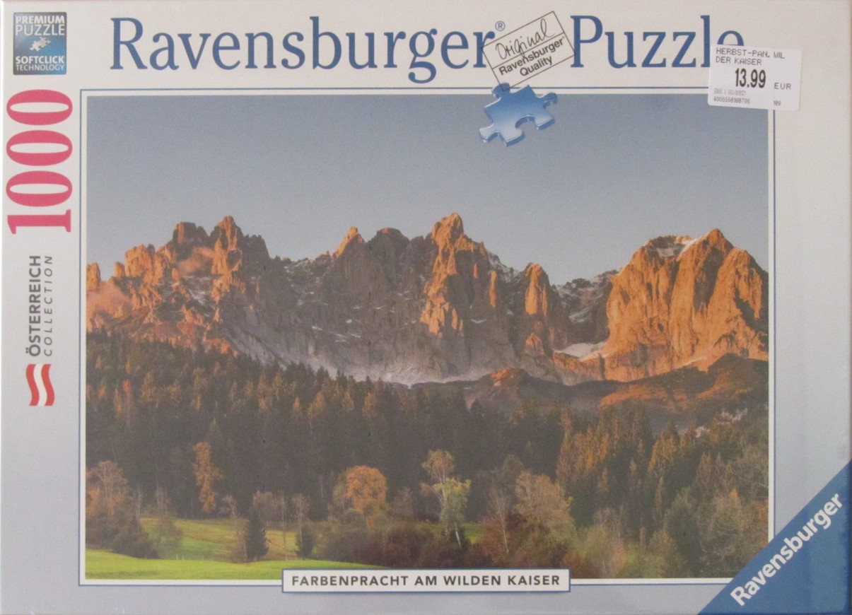A scenic photograph of the Wilder Kaiser mountains in Austria during autumn at sunset.