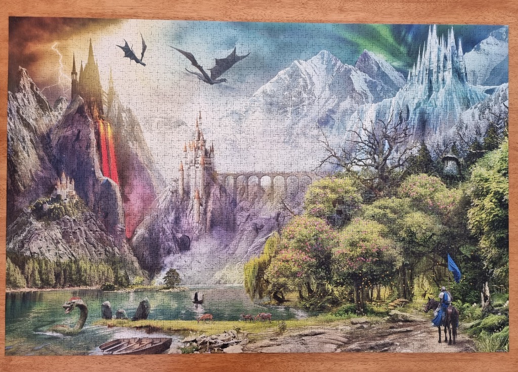 A fantasy landscape featuring castles, dragons, mountains, a lake, and a knight on horseback.