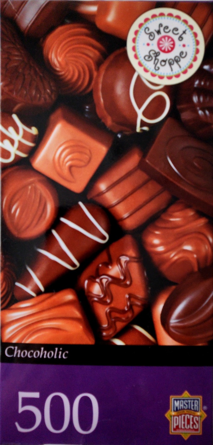 A close-up photograph of an assortment of various milk and dark chocolates.