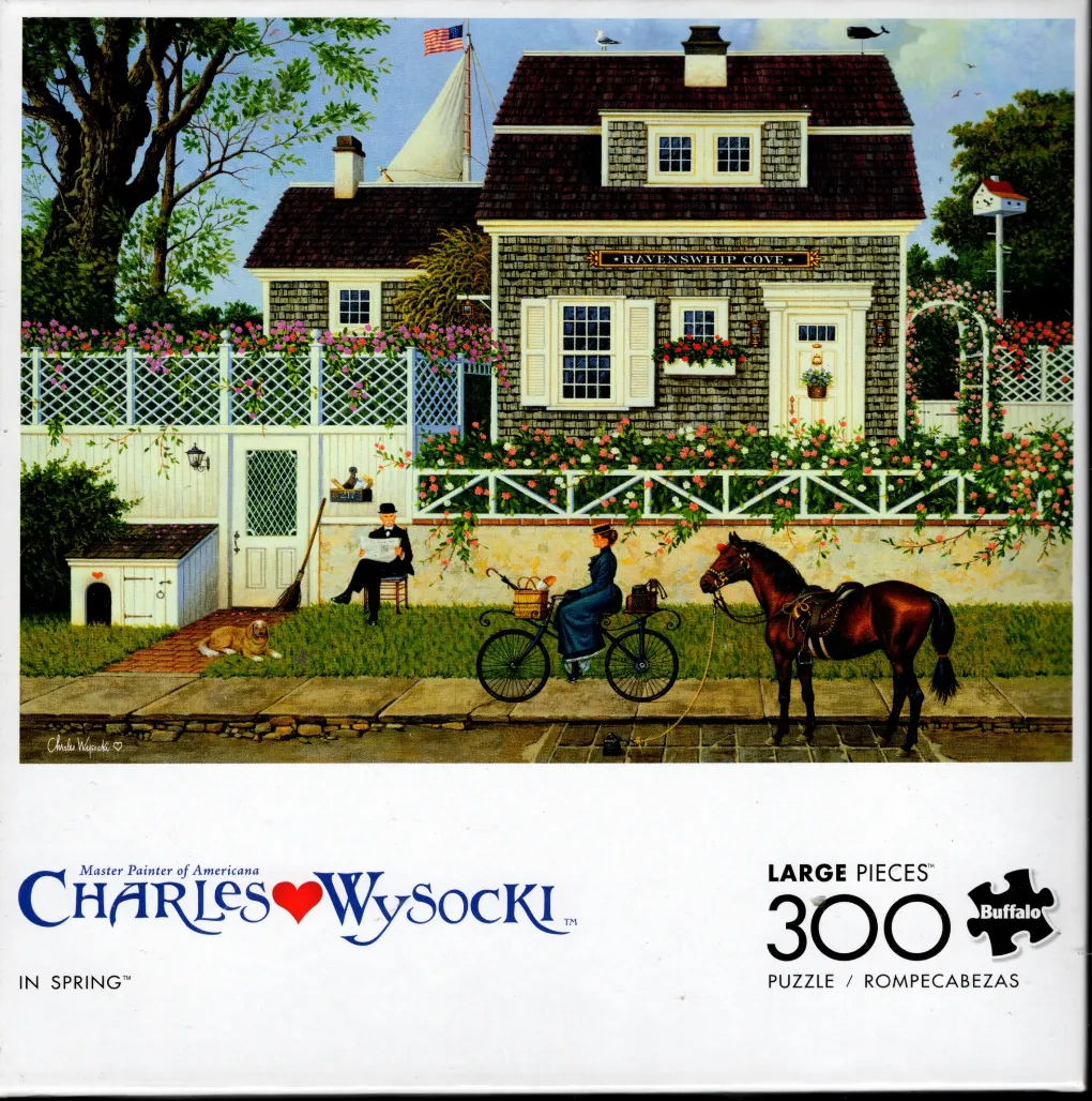 A charming Americana illustration of a grey shingled house in spring with a man reading and a woman on a bicycle.