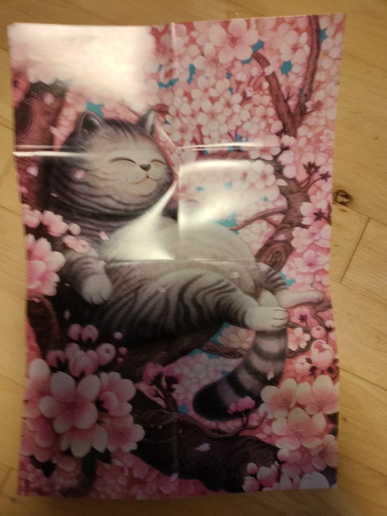 A cartoon illustration of a plump grey tabby cat lounging in a cherry blossom tree.