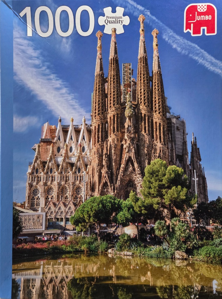 The Sagrada Familia basilica in Barcelona reflected in a foreground pond.