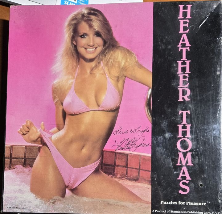 A portrait of Heather Thomas posing in a pink bikini in a hot tub against a vibrant pink background.