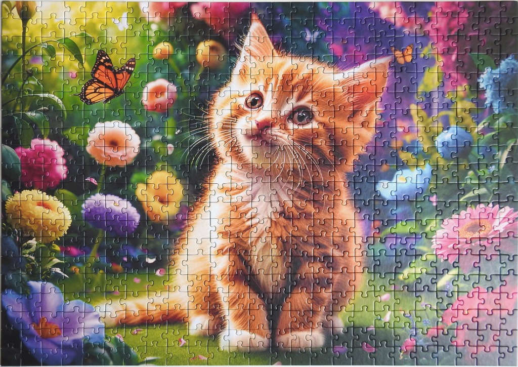 A fluffy orange kitten sitting in a vibrant, colorful flower garden with a butterfly nearby.