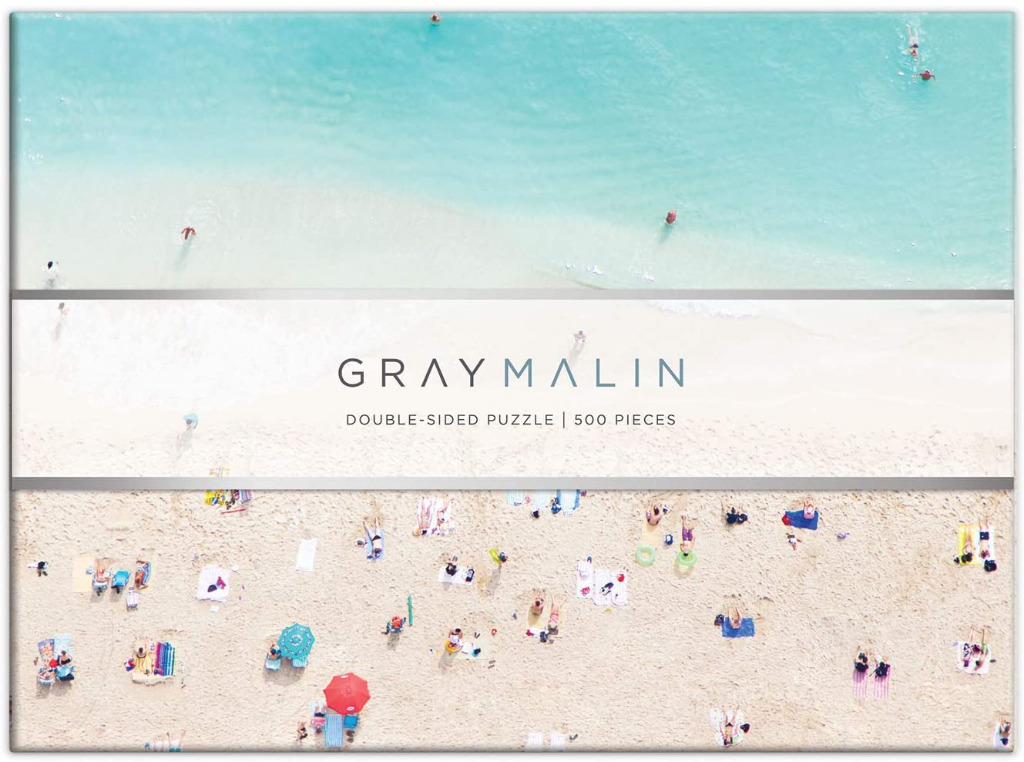 Aerial beach photography featuring a turquoise shoreline and a sandy beach with colorful towels and umbrellas.