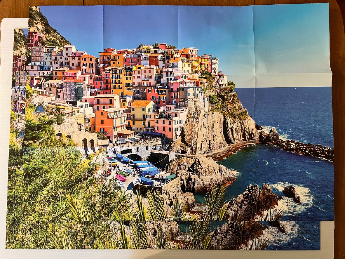 Coastal Italian village of Manarola with colorful houses built into cliffs above the sea.
